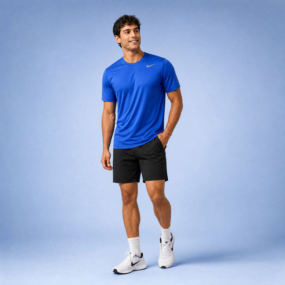 Male athlete modeling the royal blue Nike Short Sleeve Dri-FIT Athletic Shirt