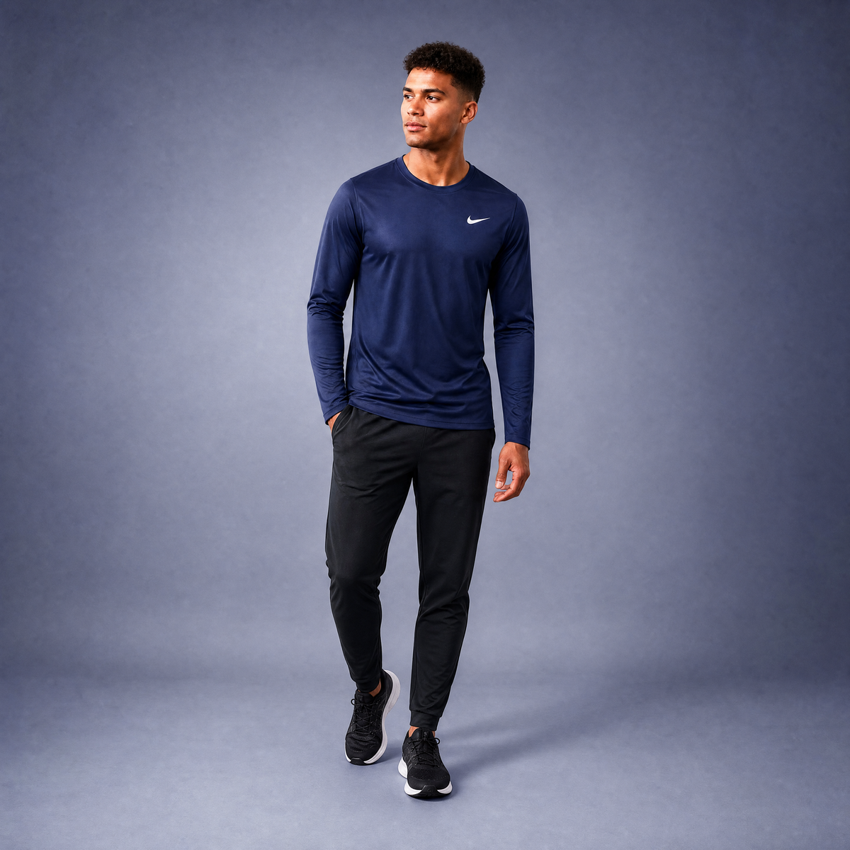 Male athlete modeling the navy Nike Long Sleeve Dri-FIT Athletic Shirt